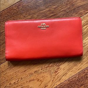 Red Coach wallet with gold accents